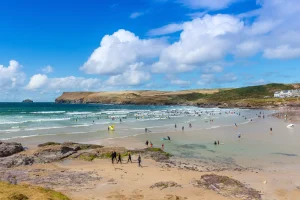Surfers and beach visitors at Polzeath Beach in Cornwall