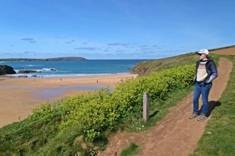 Walker on coast path at Trevone Bay